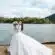 woman holding bouquet of flowers wearing wedding dress standing on dock during day