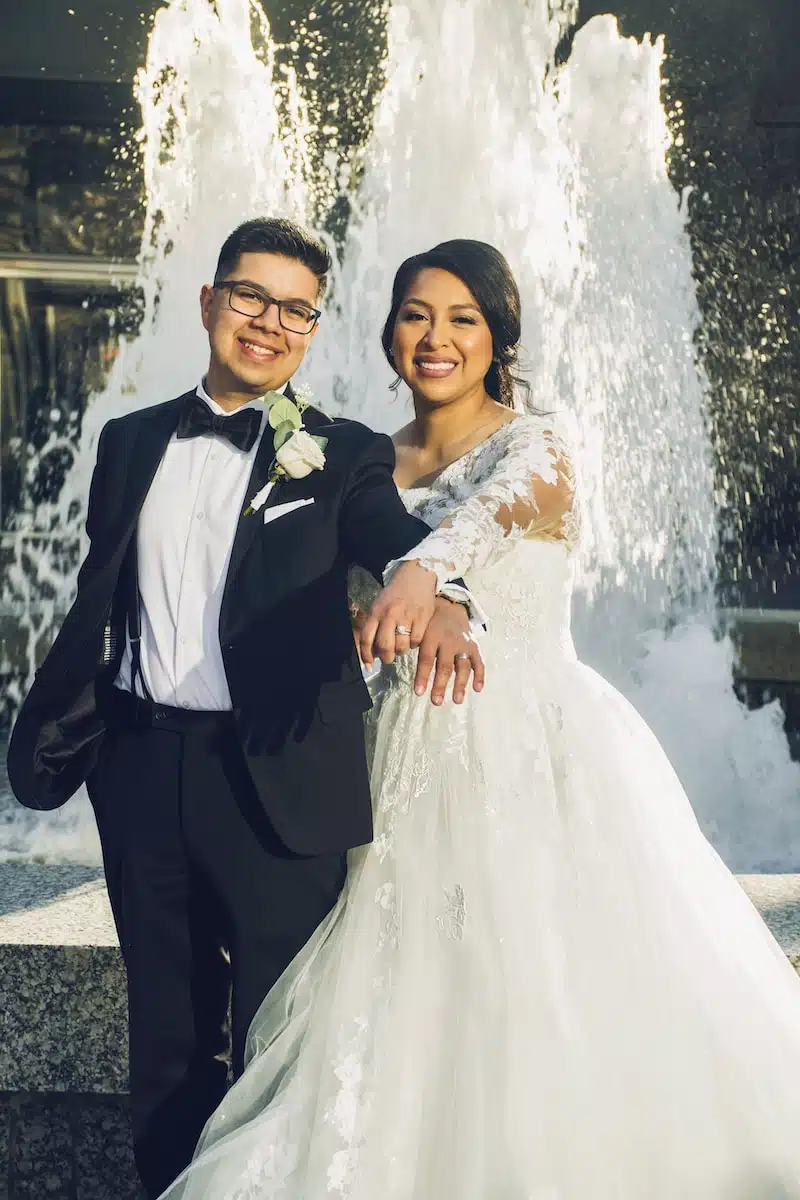 man in black suit and woman in white wedding dress