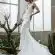 woman in white wedding dress standing beside green plant